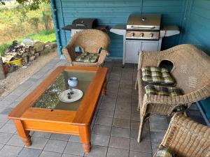 a patio with a table and chairs and a stove at Mein alter Bauernhof Strassburgerhof in Welling