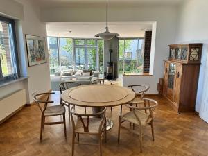 a living room with a table and chairs and a couch at Havelhaus Werder in Glindow +47 photos