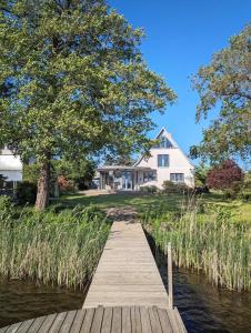 a wooden dock in front of a house at Havelhaus Werder in Glindow