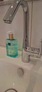 a sink with a faucet and a box of toothpaste at City-Appartement Pirna in Pirna