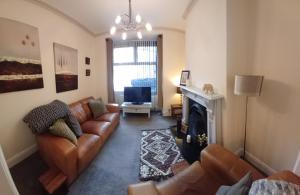a living room with a couch and a fireplace at Central Guisborough townhouse in Hutton Gate Station
