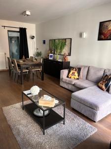 a living room with a couch and a table at BnB Antwerp Centrum in Antwerp