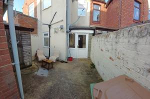 an empty alley with chairs and a building at Central Guisborough townhouse in Hutton Gate Station