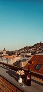 a bottle of wine and a glass on a ledge at AMARCORD BOUTIQUE HOTEL in Tbilisi City