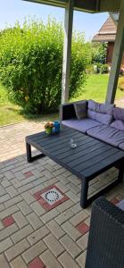 a purple couch sitting on a table on a patio at Burgblick in Kemnath