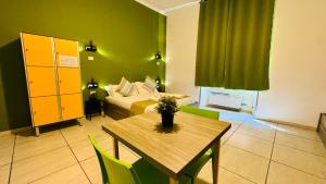 a room with a bed and a table and a bed at Star City Guest House in Rome