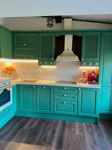 a kitchen with green cabinets and a sink at Villa Sunny Day in St. St. Constantine and Helena