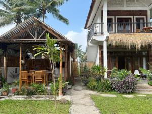 a house with a patio and a table in the yard at Stay Together in Tetebatu