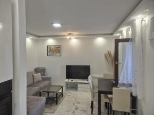 a living room with a couch and a television at Pag House in Pag