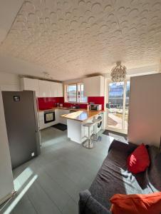 a living room with a couch and a kitchen at Dana-Large Room in a Shared House-Close to City & ANU-1 in Downer