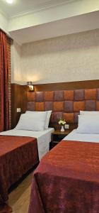 a hotel room with two beds in a room at AMARCORD BOUTIQUE HOTEL in Tbilisi City