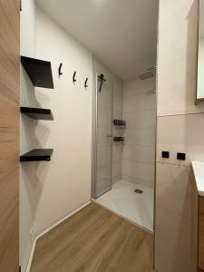 a bathroom with a shower and a glass door at Oetztal Auszeit Top 7 in Umhausen