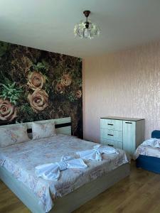 a bedroom with a bed with a floral wall at Villa Sunny Day in St. St. Constantine and Helena