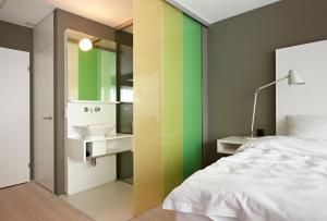 a bedroom with a sink and a mirror at Hotel Restaurant Rössli in Bad Ragaz