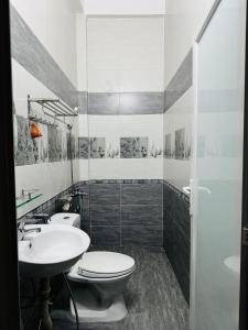 a bathroom with a toilet and a sink at Kha Phat Central Dalat with Local Charm in Xuan An +32 photos
