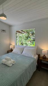 a bedroom with a bed with two towels on it at Viva Vida Caraiva in Caraíva