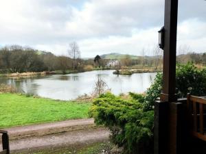 a view of a river from a house at Kingfisher Lodge, Lakeside Lodges in Dulverton