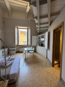 a room with a bed and a table in it at Loft Termini in Siena +17 photos