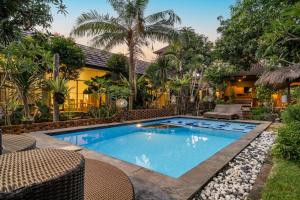 an image of a swimming pool in front of a house at Vande Guest House in Canggu