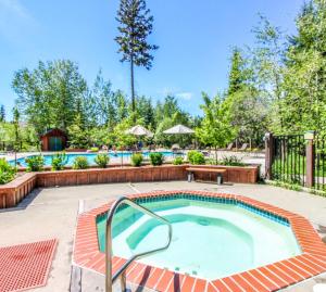 a pool with a hot tub in a yard at Violet Retreat in McCall