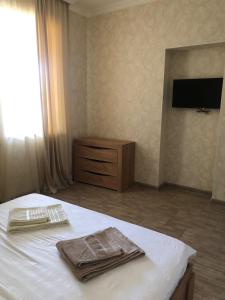 a bedroom with a bed with two towels on it at Veni Vedi in Vedi
