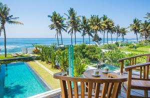 a view of the ocean from the balcony of a resort at Bali Diamond Estates & Villas in Keramas