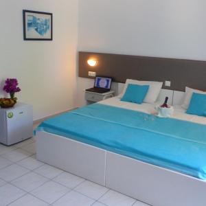 Postel nebo postele na pokoji v ubytování Blue Nest Hotel