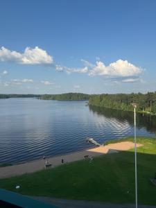 a view of a large lake with trees in the background at Hotelli Terme 614 in Ikaalinen