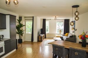 a living room with a table and a couch at Hotel Tongerlo in Roosendaal