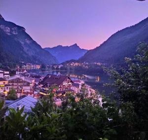 a view of a town with a lake and mountains at Appartment Alleghe center in Alleghe