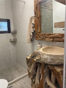 a bathroom with a stone sink and a shower at Villa Sunny Day in St. St. Constantine and Helena