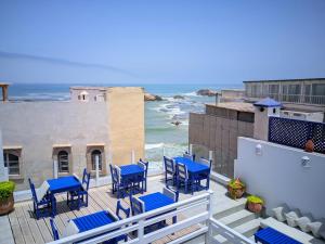 a balcony with blue chairs and a view of the ocean at La Fontaine Bleue in Essaouira +66 photos