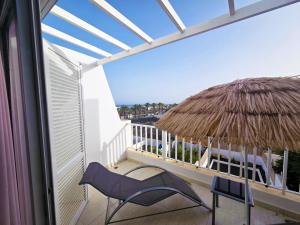 科斯塔特吉塞Duplex 2 Terraces Sea View的带椅子和草伞的阳台