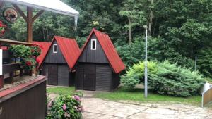 a group of small buildings with red roofs at Kemp Oparno, bezvakempy in Malé Žernoseky