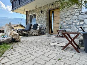 a patio with chairs and a table and a building at Haus am Berch in Weissenstein +17 photos