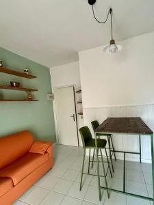 a living room with a couch and a table and chairs at Charming Tuscany in Corsanico-Bargecchia +13 photos