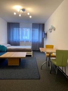 a room with a bed and two tables and chairs at Ganze Apartment in Saarbrücken City in Saarbrücken