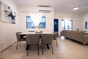 a dining room and living room with a table and chairs at Aetheria 3BR in Khlorakas