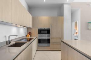 a kitchen with a sink and a stove top oven at Stunning Beach Front Condo Ocean View Pool Spa in Hollywood +15 photos