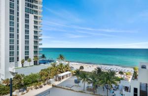 a view of the beach from the balcony of a resort at Stunning Beach Front Condo Ocean View Pool Spa in Hollywood