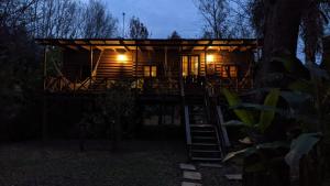 a tree house at night with the lights on at Vientos de Libertad in Estación Delta +8 photos