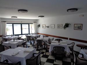a restaurant with tables and chairs in it at Hostal Restaurant s'Algaret in Fornells