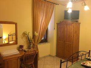 a dining room with a table and a mirror and a dresser at La Perla del Sannio in Sant'Agata de' Goti