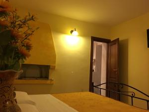 a bedroom with a bed with a vase of flowers at La Perla del Sannio in Sant'Agata de' Goti