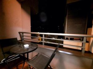 a balcony with a table and chairs and a window at AnyBL02 in Hiseti