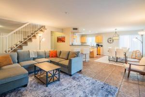 a living room with a couch and a table at NEW Desert Daze, near Golf, Heated Pool+Spa, 12ppl in Scottsdale