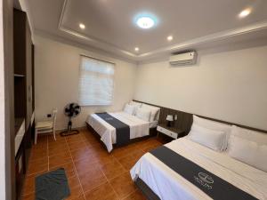 Postel nebo postele na pokoji v ubytování Resort Mộc Hồ