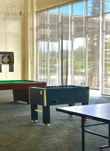 a room with two tables and a pool table at Skye Studio in Kaybagal +15 photos