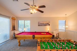 a room with a pool table and a ceiling fan at NEW Desert Daze, near Golf, Heated Pool+Spa, 12ppl in Scottsdale