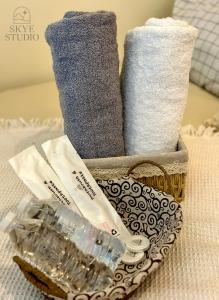a basket of towels and a bottle of water and towels at Tagaytay Condo - Skye Studio in Kaybagal +16 photos